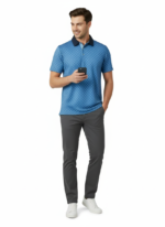 Man wearing a blue patterned polo shirt, gray pants, and white sneakers, standing against a white background while holding a phone.