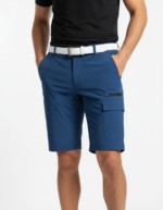 Front view of a man wearing blue cargo shorts with a white belt and a black polo shirt, standing with hands in pockets.