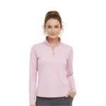 Woman wearing a light pink women's golf quarter-zip top with long sleeves and a high collar, posing in gray pants.