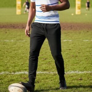 Man wearing black men’s rugby joggers with drawstring waist on a grass rugby field.