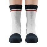 Pair of white athletic crew socks with dark navy cuffs, featuring a red-brown and white horizontal stripe band near the top, shown side-by-side on a white background.