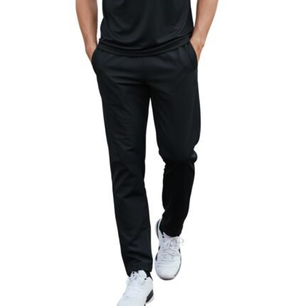 Man in black athletic t-shirt and track pants walking forward on white background — fitness apparel model