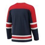 Back view of a navy blue hockey jersey with red shoulders and red and white stripe accents on the sleeves and hem