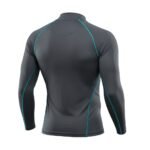 A close-up view of the back of a long-sleeved, fitted gray athletic shirt with teal stitching accents. The shirt is designed for performance and moisture-wicking.