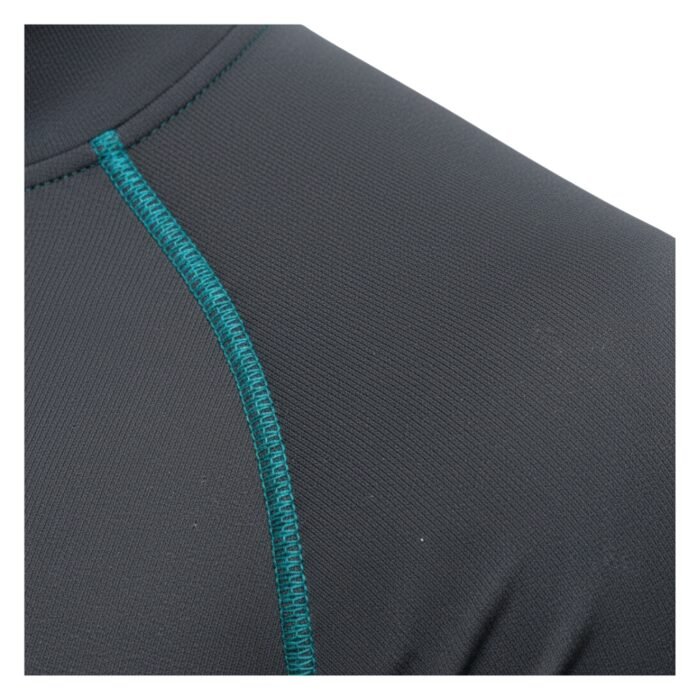 A close-up of the seam detailing on a gray athletic shirt, featuring teal stitching on a smooth, performance fabric.
