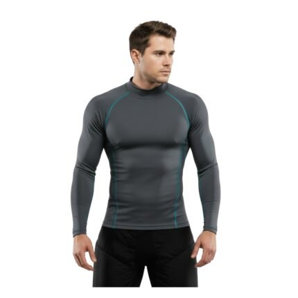 A man wearing a fitted gray long-sleeve athletic shirt with turquoise accents, paired with black athletic pants, standing against a white background.