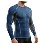 A man wearing a blue and black long-sleeve athletic shirt with geometric patterns on the chest and detailed stitching, designed for functionality and style.