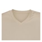 Close-up view of the V-neck collar design on a beige ice hockey team jersey.