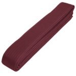 A neatly folded maroon martial arts belt.