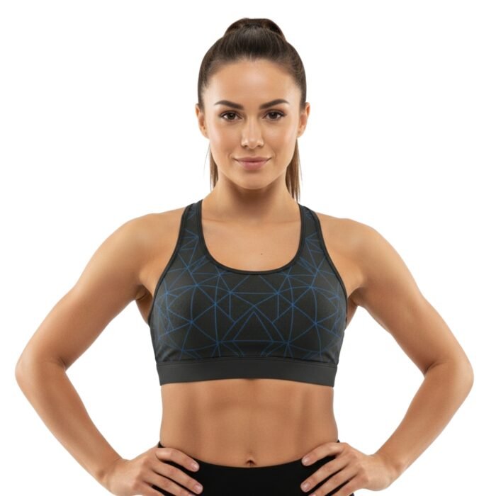 Person wearing a black sports bra with blue geometric patterns, posing with hands on hips.