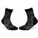 Black ankle socks with gray pixel-camo graphic pattern and cushioned black toe and heel.