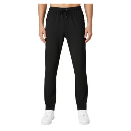 Front view of a person wearing black jogger pants with an elastic waistband, black drawstring, and white sneakers.