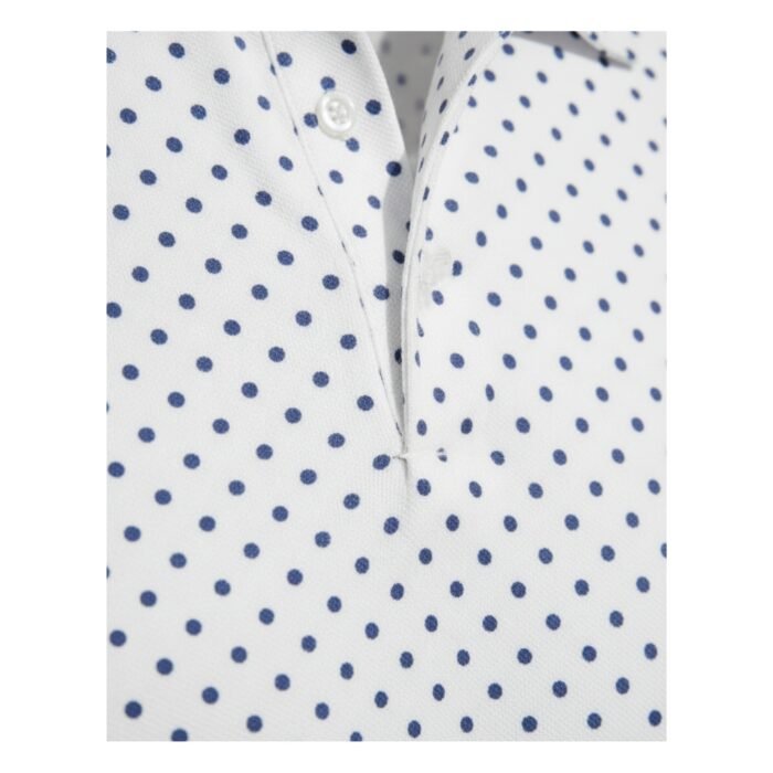 White polo shirt with an all-over blue dotted print, collared neckline, and short sleeves with a button placket