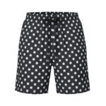 Black shorts with a white polka dot pattern, elastic waistband, and black drawstring.