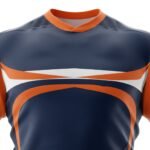 Close-up of a navy rugby jersey with orange collar trim, orange sleeve panels, and bold white-and-orange graphic bands across the chest