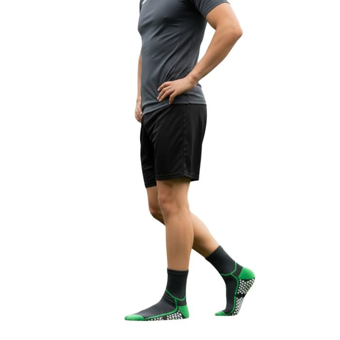 Side view of a model wearing soccer grip socks, showing the fit around the ankle and foot on a plain background