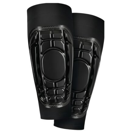 Soccer shinguard sleeves laid flat on a plain background