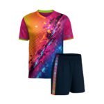 Athletic jersey and shorts set: vibrant left-to-right gradient (orange/pink → blue/pink/purple) with abstract lightning bolt on chest, green-trimmed V-neck and sleeves, paired with dark blue shorts featuring orange-and-blue side stripe.
