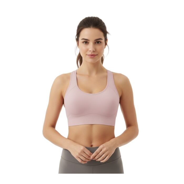 A person wearing a light pink sports bra and gray leggings, standing against a white background