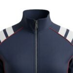 Silver metal front zipper centered on a navy textured performance fabric jacket, with clean stitching and subtle fabric tension; ribbed navy collar visible above.