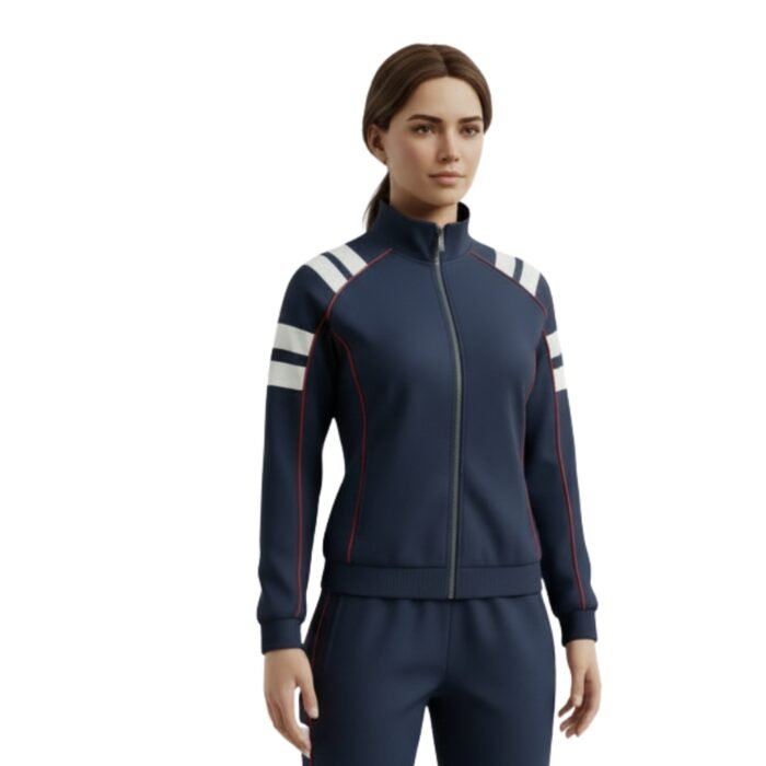 A woman with shoulder-length dark hair wears a fitted navy track jacket and matching trousers. The jacket is fully zipped, features ribbed navy collar and cuffs, and displays three bold white stripes with red outlines running diagonally across each shoulder and continuing onto the upper arms.