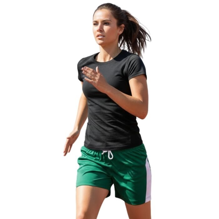 A woman with her hair in a ponytail running on an outdoor track, wearing a black t-shirt and green rugby shorts with a white stripe down the side