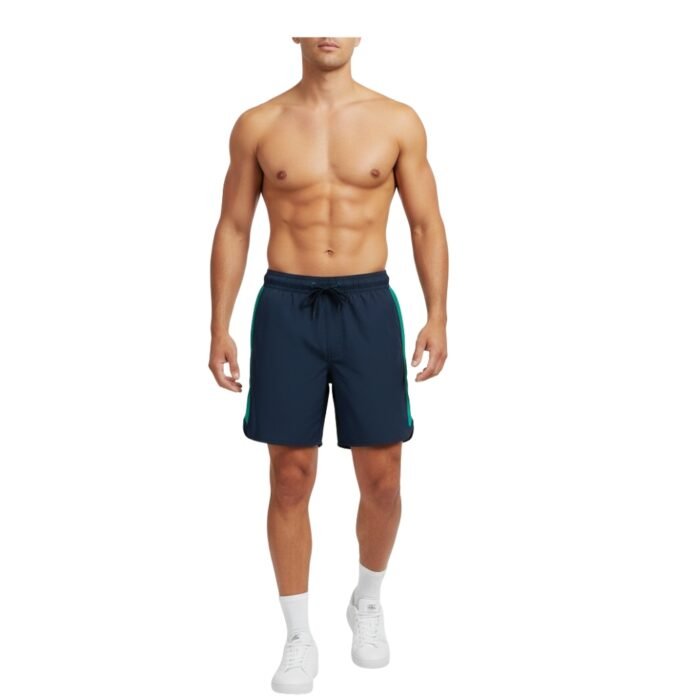 Front-facing shot of a shirtless male athlete wearing navy rugby training shorts with 2.5 cm wide vertical green side stripes, elastic waistband with black drawstring and matte black aglets, clean 3–4 cm side slits at hem, and a welt-style back pocket partially visible on the right hip. Plain white studio background.