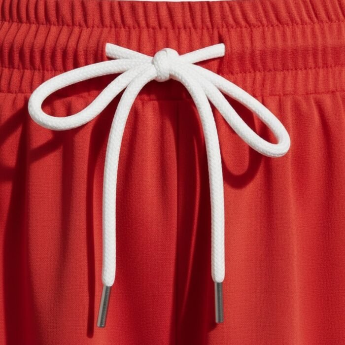 Red women’s soccer skort with adjustable white front drawstring tie and elastic waistband
