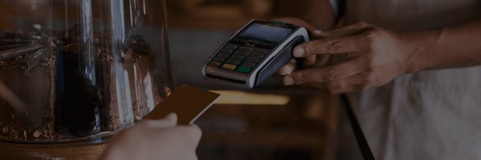 A man swapping a card in a card POS machine to use his account.