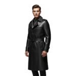 Man wearing a black leather long coat with a belted waist and buttoned collar.