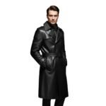 Man wearing a black leather long coat with a belted waist, buttoned double-breasted front, and hands in the pockets.