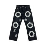Dark wash women's denim jeans with floral circle embroidery and knee tears, flat-lay on white background.