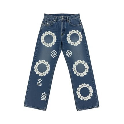 Dark blue women's ripped denim jeans with white floral and geometric embroidery patterns displayed on a white background.