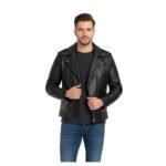 A man wearing a stylish black leather jacket with quilted accents, asymmetrical zippers, and silver hardware. He pairs it with a black t-shirt and blue jeans, standing against a white background.