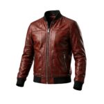 Reddish-brown distressed leather bomber jacket with black ribbed collar, cuffs, and hem, full front zipper, flapped chest pockets, and zippered hand pockets on a white background.