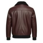 Rear view of a deep burgundy leather jacket with a textured finish, featuring a black, soft shearling-style collar and ribbed black cuffs and waistband.