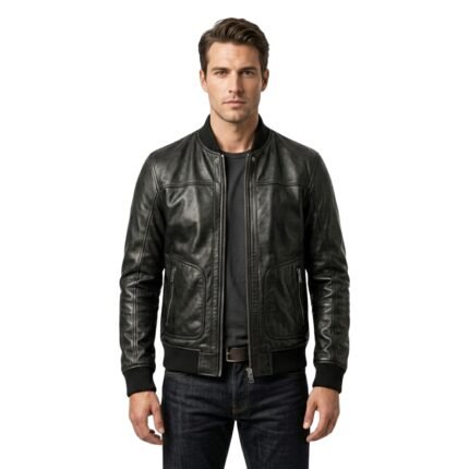 Man wearing a black leather bomber jacket over a dark gray t-shirt and dark jeans, standing against a white background.