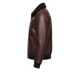 Side view of a deep burgundy leather jacket with a textured finish, featuring a black shearling-style collar, zippered pockets, and ribbed black cuffs and waistband.