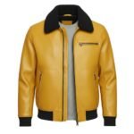 Front view of a mustard yellow leather jacket with a textured finish, featuring a black shearling-style collar, zippered chest and side pockets, and ribbed black cuffs and waistband.