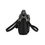 Side view of a black leather crossbody mini bag showing adjustable detachable straps and textured leather finish.