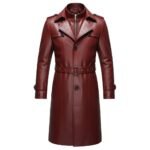 A red leather trench coat with a belted waist, button closures, structured lapels, and detailed craftsmanship.