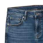 Close-up of classic blue denim jeans showing the waistband, belt loops, centered metal button, zip fly, and front pocket stitching with visible cotton twill texture.