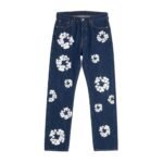 Dark blue jeans with stylized white floral patterns on both legs, laid flat on a white background, button fly.