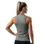 Back view of a woman wearing a high-neck sleeveless tank top, standing against a white background.