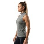 Side view of a woman wearing a high-neck sleeveless tank top, standing against a white background.
