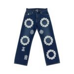 Navy blue women's denim jeans with white floral wreath and ornamental embroidery across the legs, featuring distressed knee rips, laid flat on a white background.