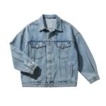 Oversized light-wash denim jacket with button-front and chest flap pockets, shown on a plain background.