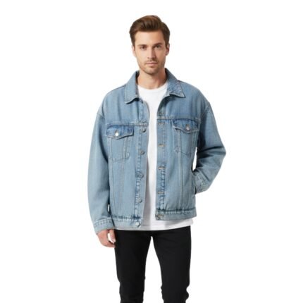 Light-wash denim jacket on a model with button-front closure and flap chest pockets, paired with a white T-shirt and black pants.