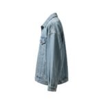 Oversized light-wash denim jacket shown in a side profile with a classic collar, button-front detail, and button cuffs.