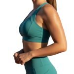 Woman wearing running sports bra, side model view.